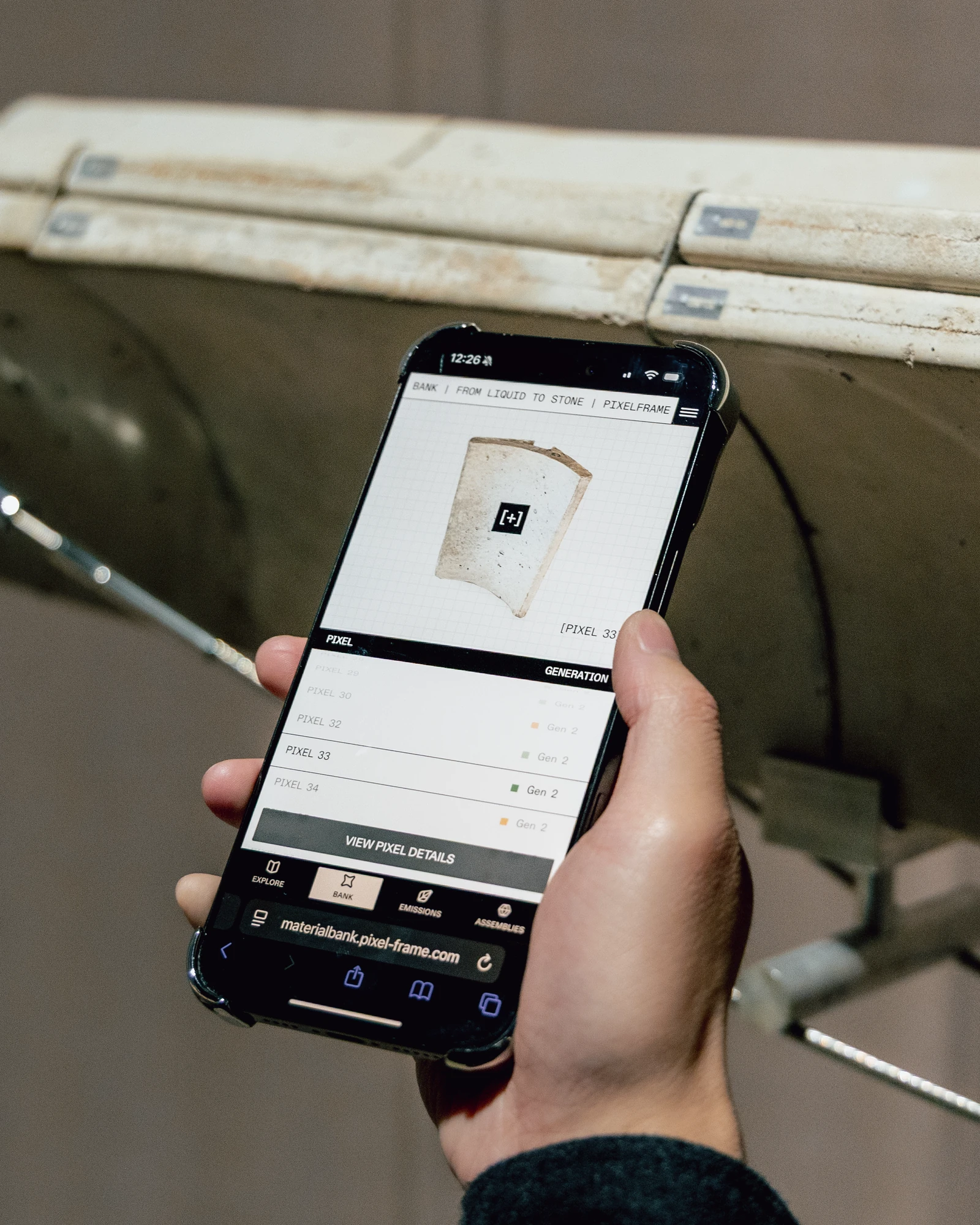 Visitor scanning an RFID tag on a Pixelframe concrete module to open its material passport